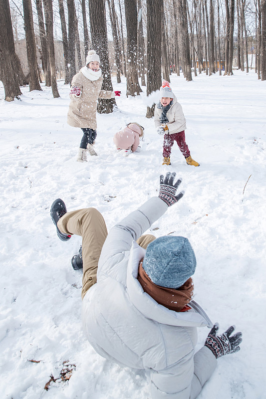 雪地里打雪仗的快樂家庭圖片素材