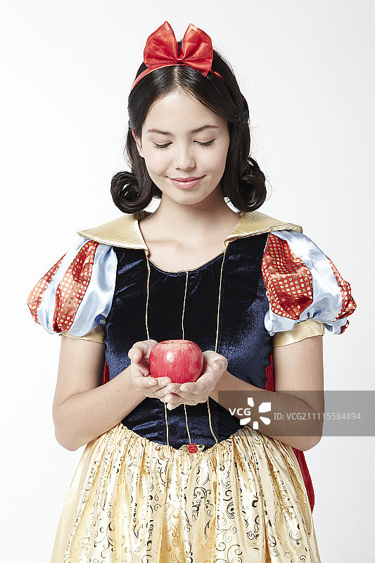 穿着白雪公主服装的女人拿着一个苹果图片素材