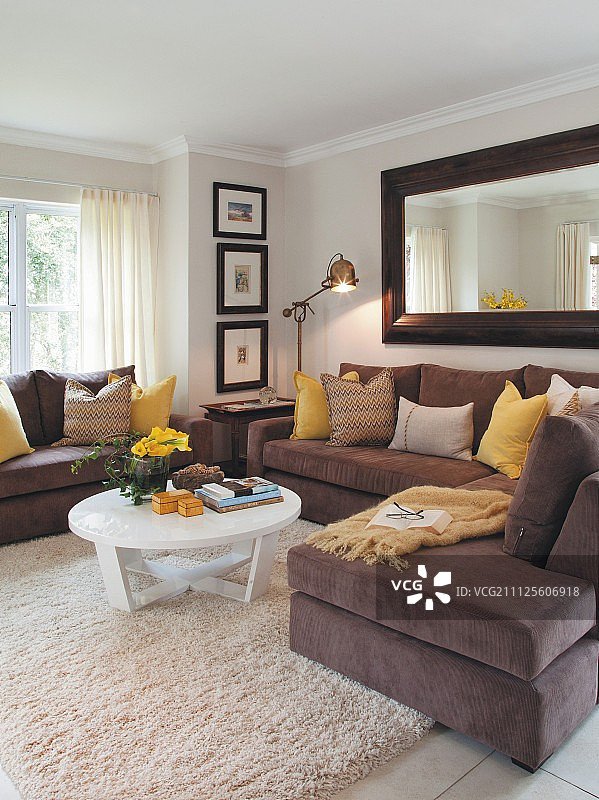 在传统的客厅里，角落里有棕色的沙发和白色的咖啡桌，上面铺着柏柏尔地毯图片素材