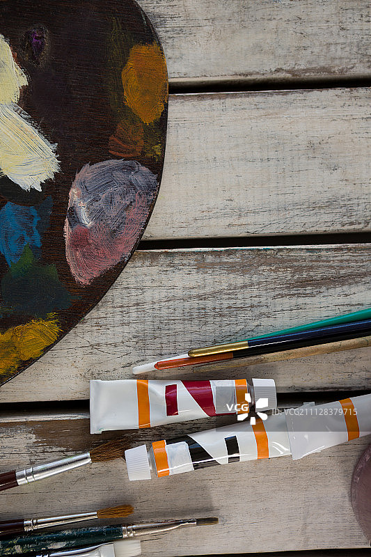特写水彩颜料，调色板和画笔在木制表面图片素材