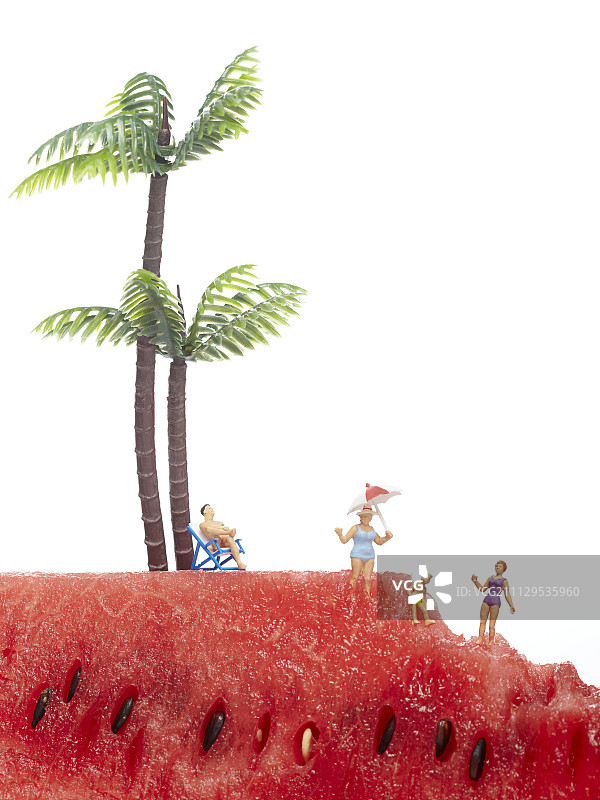 西瓜上有棕榈树的家庭雕像图片素材
