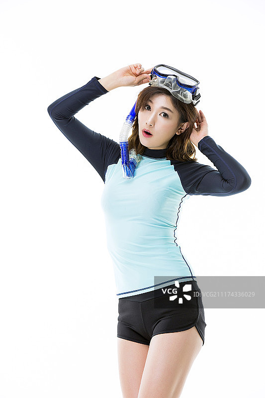 美丽的亚洲女人在鲁莽的警卫/冲浪者的服装图片素材