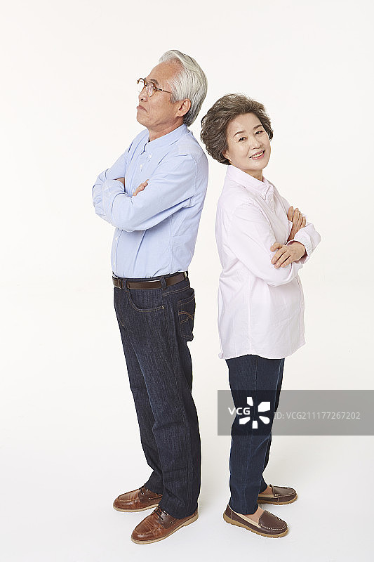 老年夫妇背靠背双臂交叉的照片图片素材