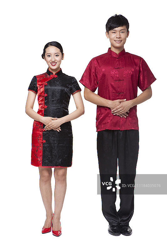穿着中国传统服饰的男女手合十站立摄影图片素材