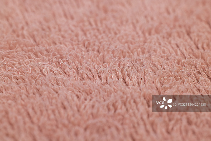 柔软的织物纹理接近，全帧镜头的粉红色织物图片素材