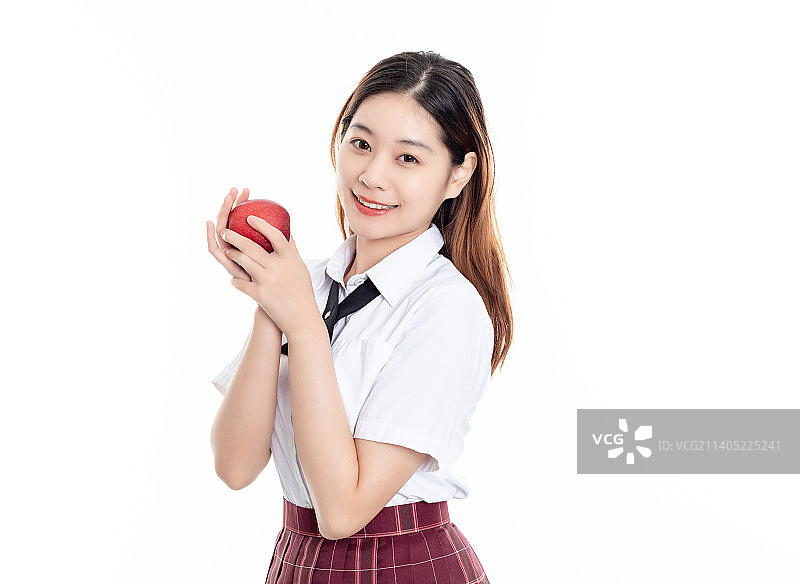 白底中一名漂亮的中国女大学生在吃苹果图片素材
