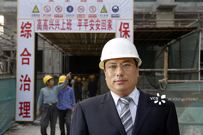 商务男士站在建筑工地前图片素材