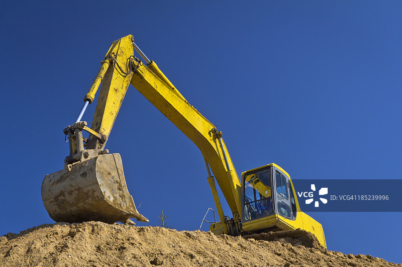 黄色的挖掘机映衬着蓝天图片素材
