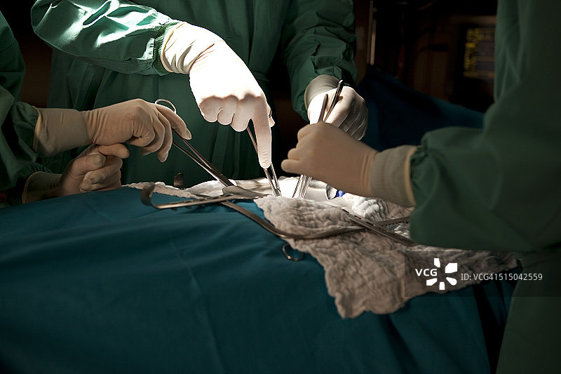 医生和护士在手术室里给病人做手术，手的细节图片素材