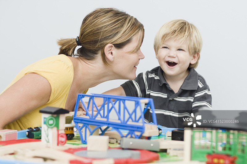 妈妈和儿子在玩玩具火车图片素材