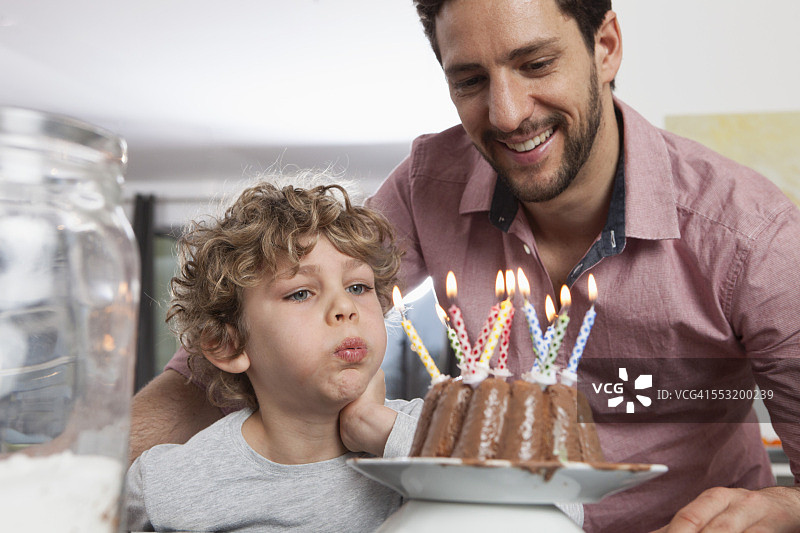 父亲和儿子与生日蛋糕图片素材