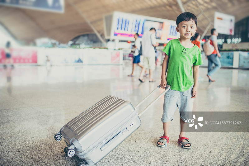可爱的小男孩在机场等着，孩子旅行图片素材