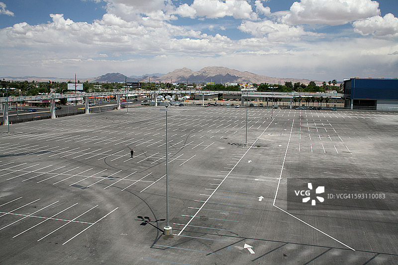 一个男人站在一个空停车场的中央图片素材