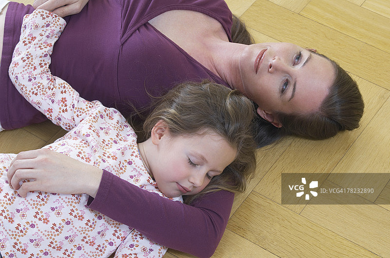高角度观看母女躺在地板上小女孩睡觉图片素材