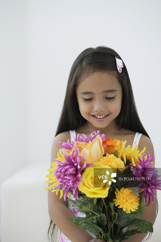 一个年轻的女孩拿着一束花图片素材