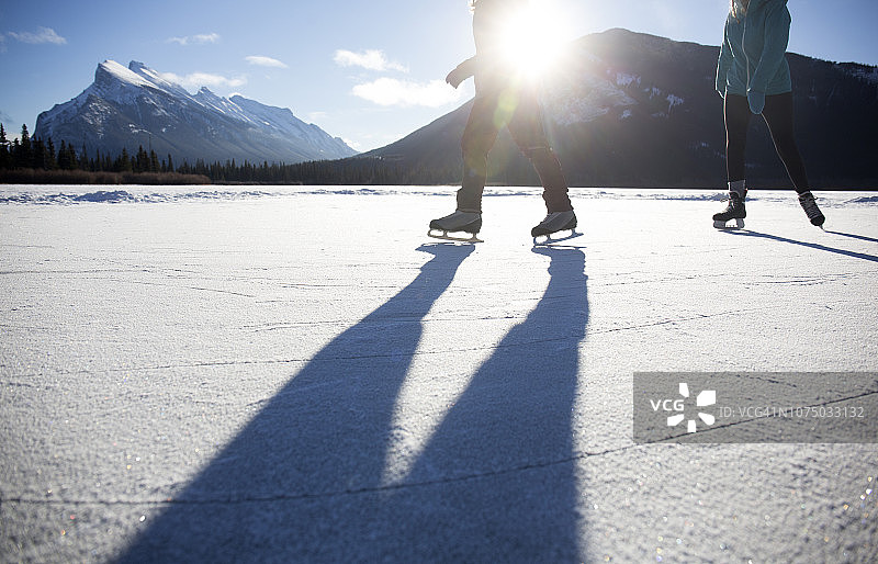 女士们在结冰的湖面上滑冰。图片素材