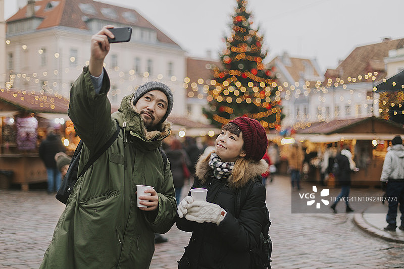 一对情侣在圣诞市场自拍图片素材