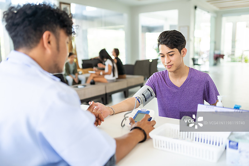 泰国青少年与医生交谈并测量血压图片素材