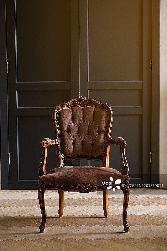 客厅黑门前的米色丝绒椅子。这个房间的内部设计成复古风格。彩色照片。图片素材