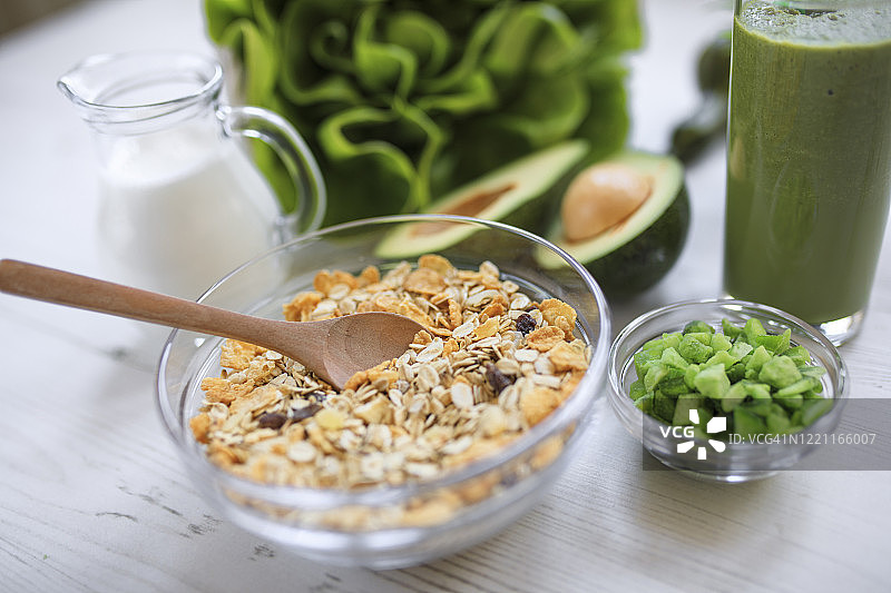 新鲜的绿色排毒奶昔，搭配格兰诺拉麦片早餐图片素材