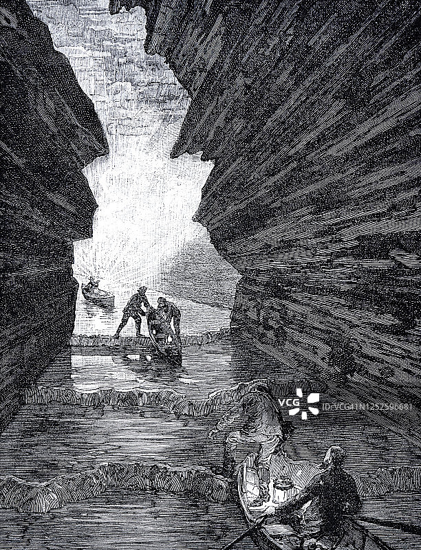 在洞穴里划船的冒险者图片素材