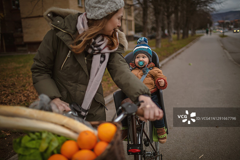 宝宝喜欢在冬天和妈妈一起骑自行车图片素材