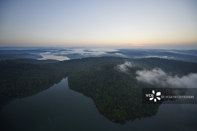 鸟瞰图森林湖岸在雾蒙蒙的黎明图片素材