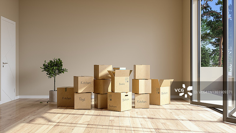 搬进或搬出一所房子。空房间里的纸板箱上面写着物品属于哪个房间。图片素材