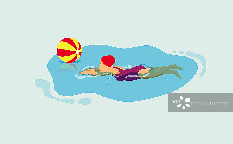 戴着红色游泳帽的小女孩一边游泳一边玩沙滩球。图片素材