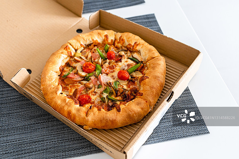 一个人的披萨。盒子里的迷你披萨。食品外卖图片素材