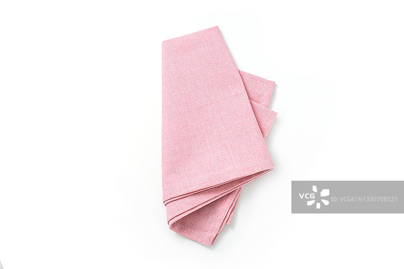 粉红色的纺织品餐巾孤立在白色的背景。图片素材