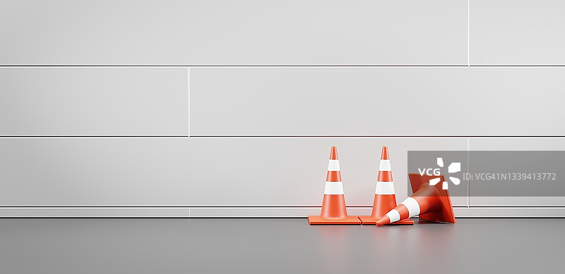 沿墙的交通锥，正面。现实的橙色警告在街道或房间与白色瓷砖墙和灰色地板，道路工程设备，建筑围栏，安全屏障，3d渲染图片素材
