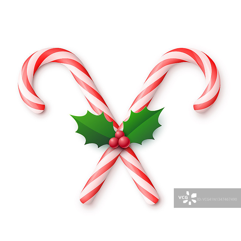 圣诞现实交叉糖果拐杖与冬青浆果和叶子在白色背景图片素材
