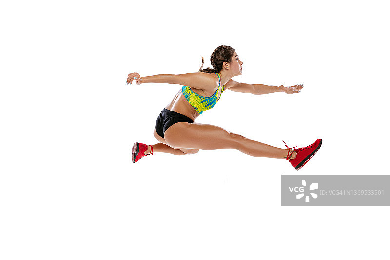 跨栏。动态肖像的职业女性跑者，运动员跳跃，孤立地跑在白色背景。运动、竞争、健康的理念图片素材