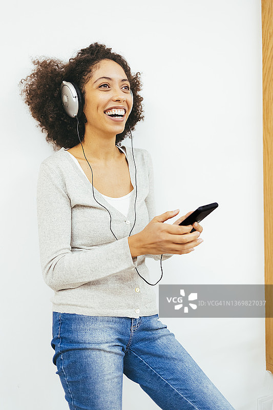 戴着耳机听音乐的快乐女人图片素材