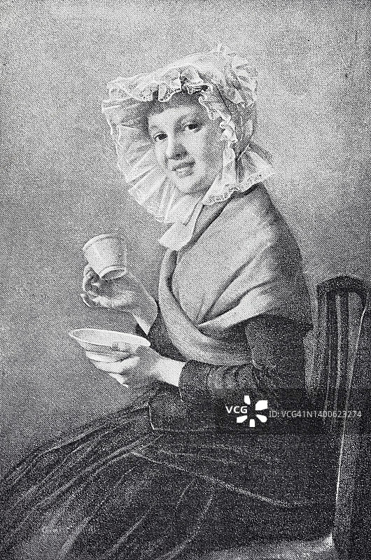 戴头巾的年轻女士在喝咖啡图片素材