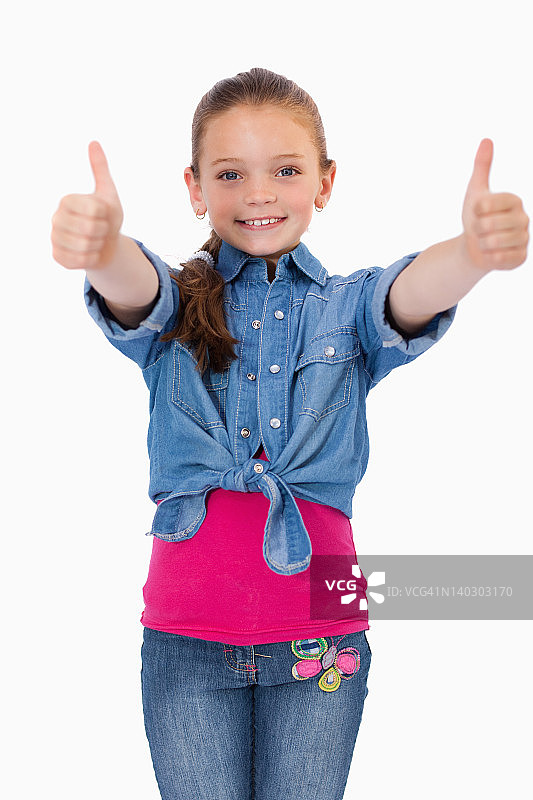 一个竖起大拇指的快乐女孩的肖像图片素材