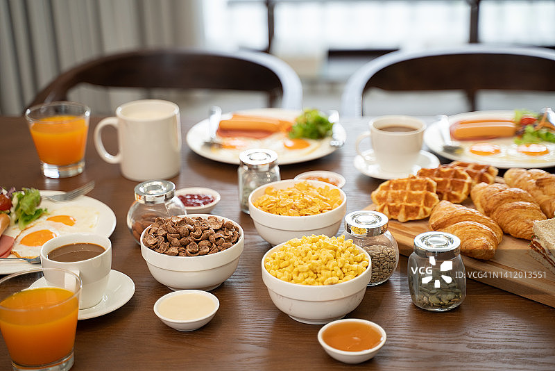 早餐有咖啡、橙汁、羊角面包、麦片和水果。均衡的饮食。图片素材