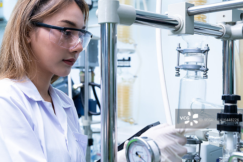 女科学家在实验室内用化学或药用精油研究和检查时的肖像照。化学工程师的工作过程，带有文本拷贝空间。图片素材