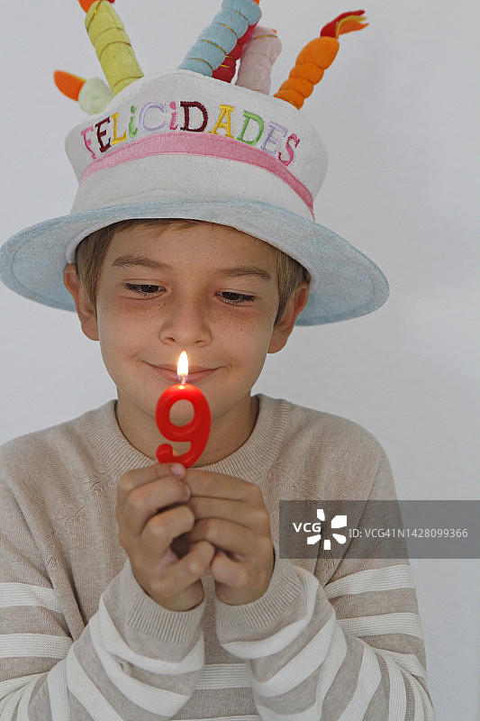 男孩在生日时举着蜡烛图片素材