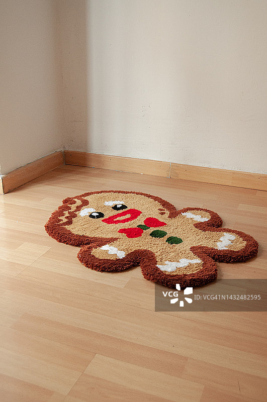 图像纺织姜饼饼干人地毯拼花地板在家庭内部。自然光和垂直格式。用天然纤维和丙烯酸纤维装饰房屋。簇绒枪艺术，2022年趋势图片素材