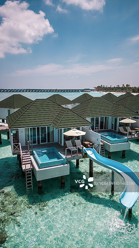 马尔代夫水别墅平房水上滑梯在绿松石酒店度假泻湖图片素材