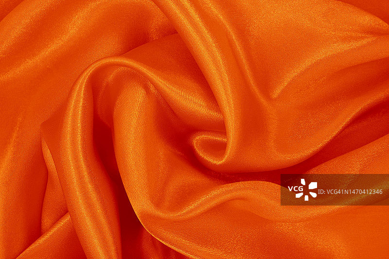 橙色的织物纹理背景，细节的丝绸或亚麻图案。图片素材