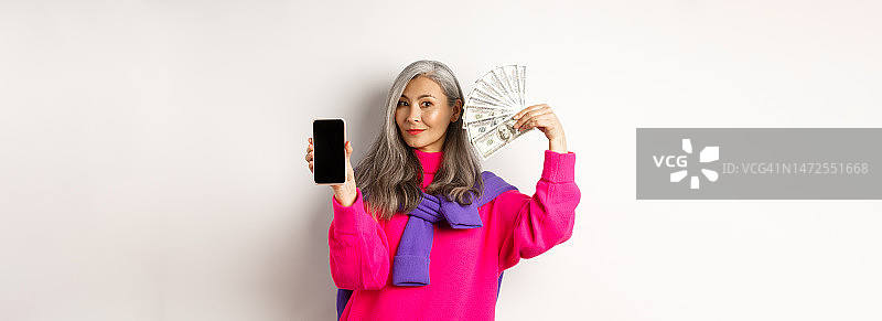 时尚的亚洲老年妇女显示金钱美元和空白图片素材
