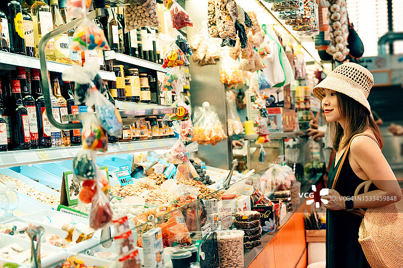 在西班牙当地食品市场购物的女游客图片素材