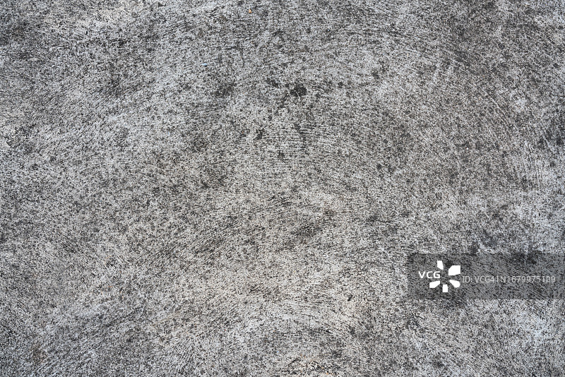 抽象旧脏暗水泥墙背景上的地面纹理。图片素材