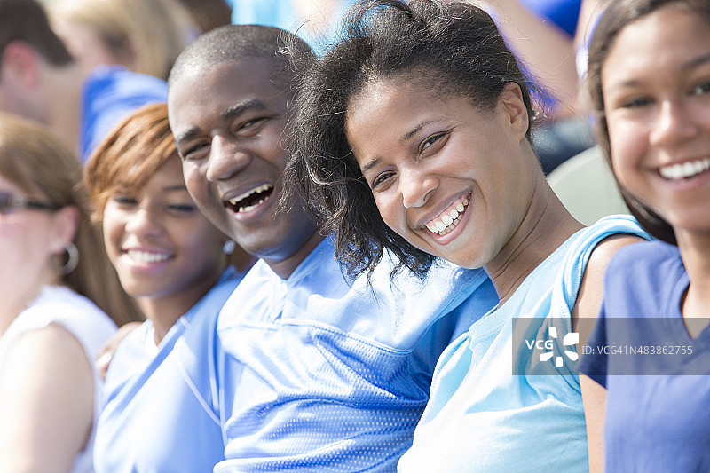 幸福的家庭一起在体育场的座位上观看体育赛事图片素材