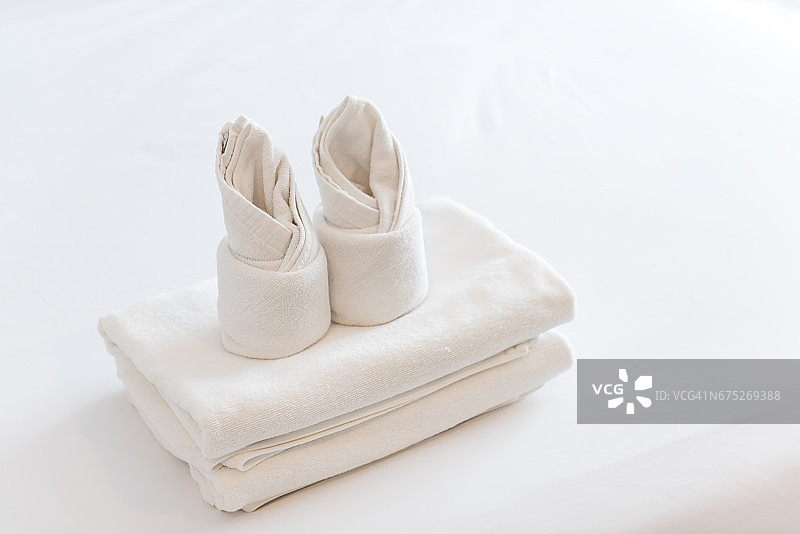 酒店卧室里折叠的白毛巾图片素材