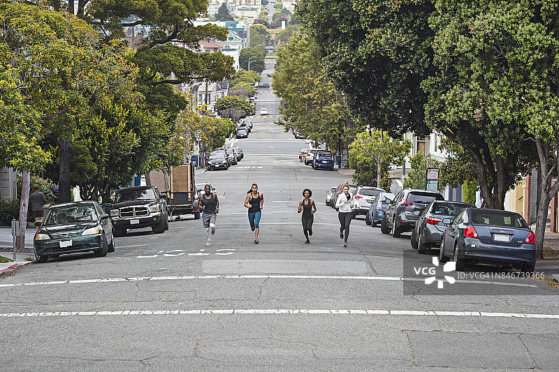 四个人在旧金山的街道上跑步图片素材