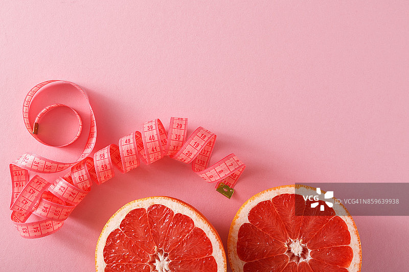 节食背景，柚子用卷尺测量图片素材